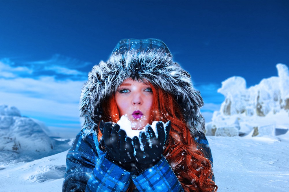 woman with red hair and blue ice in a fur parka in an ice theme, symbolizing the power of trusting your intuition