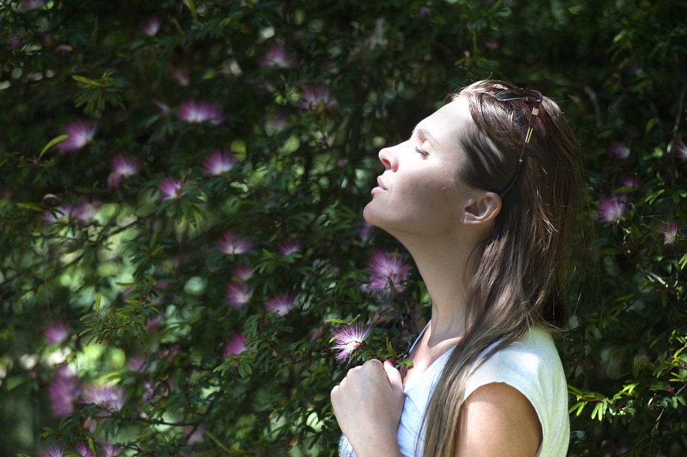 a woman outside in the nature, enjoying herself, self care is not selfish