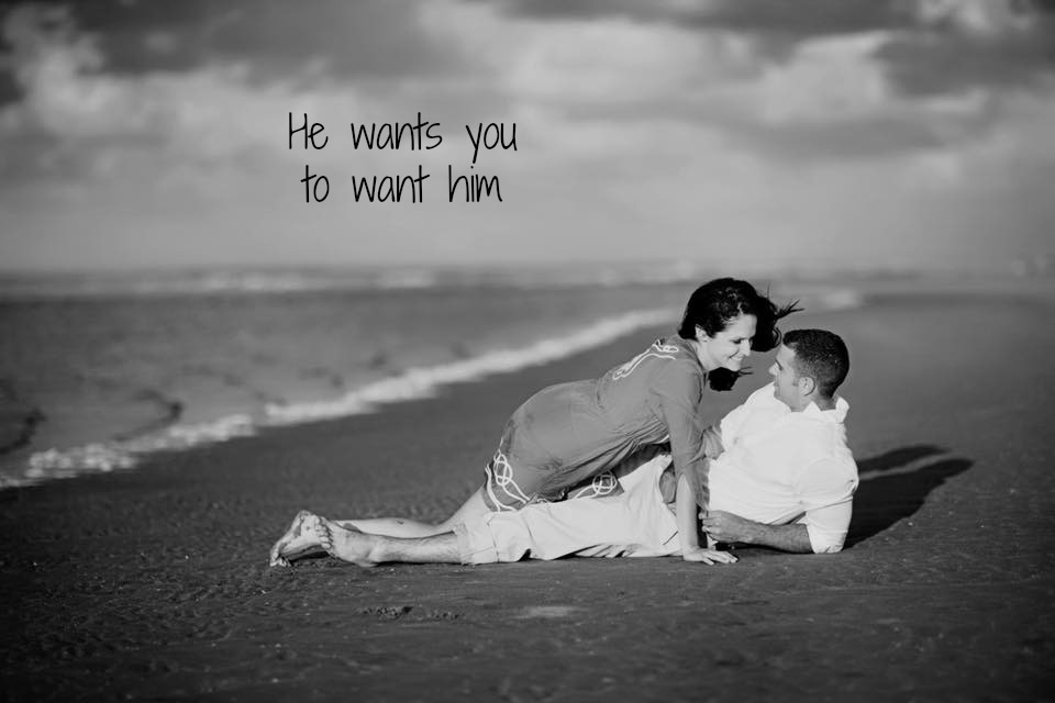 couple laying in the sand on the beach, teasing each other, wording on image, he wants you to want him, find the perfect man and prevent heartbreak