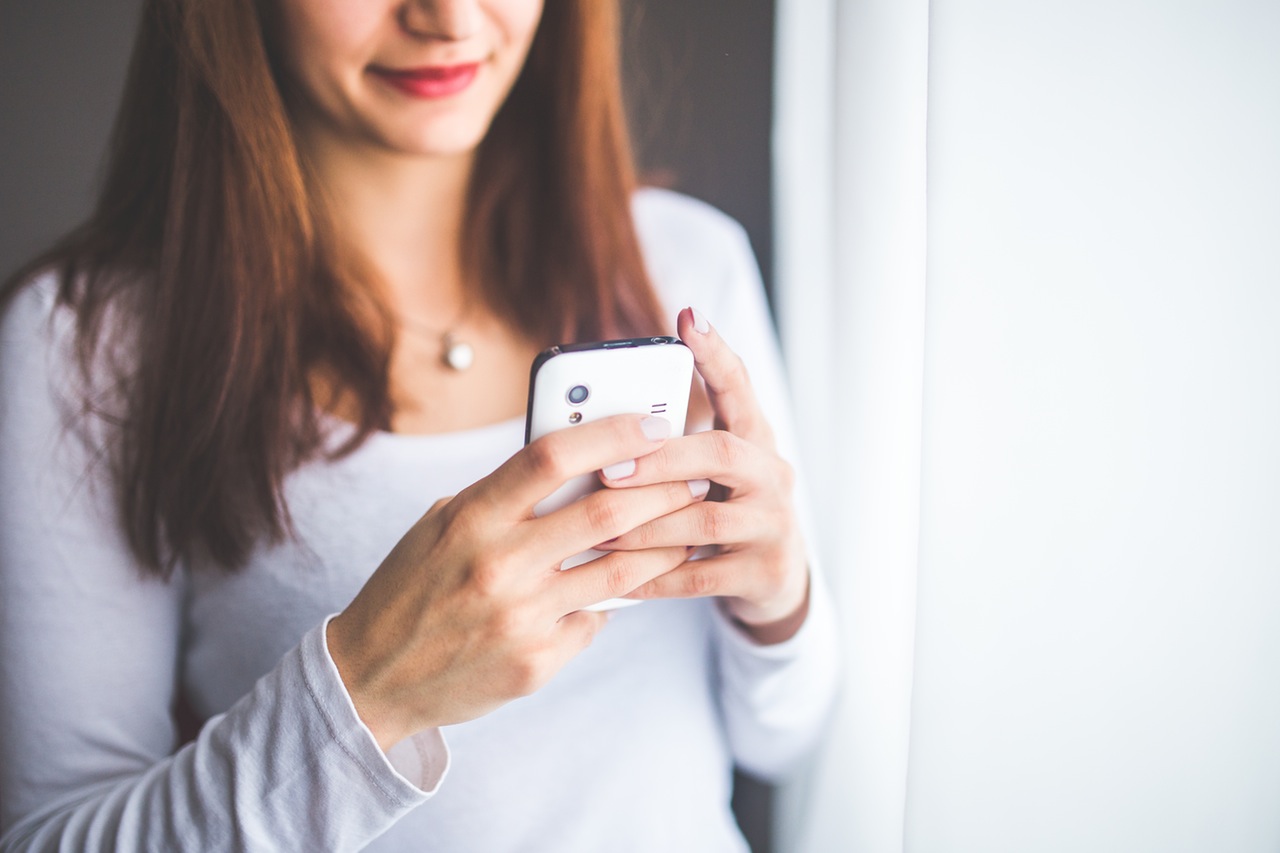 woman with a cup of coffee in her hand, wondering why the perfect man she found doesn't call her back