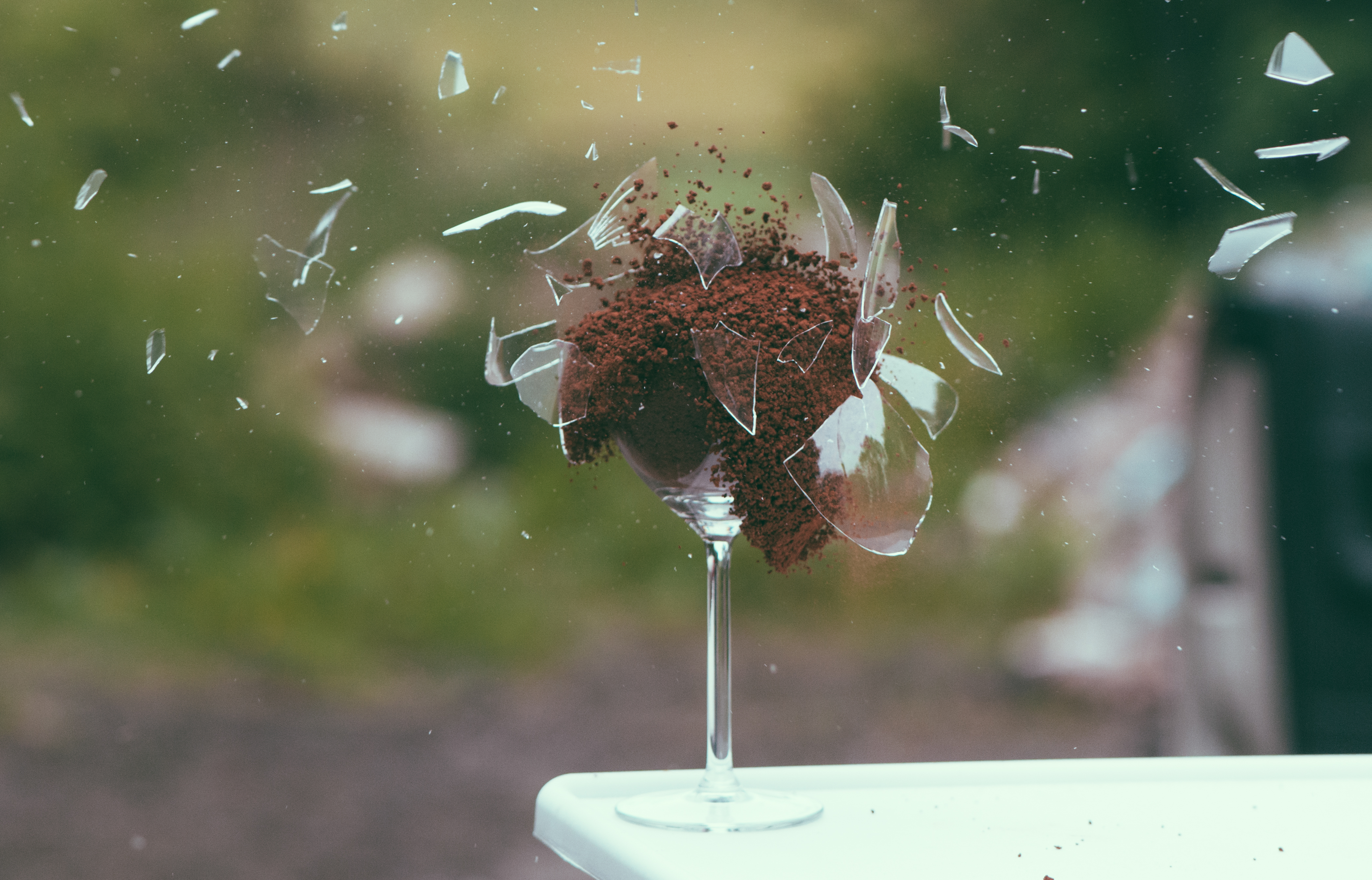 glass on top of table, filled with seeds, exploding, showing the power of being vulnerable with someone