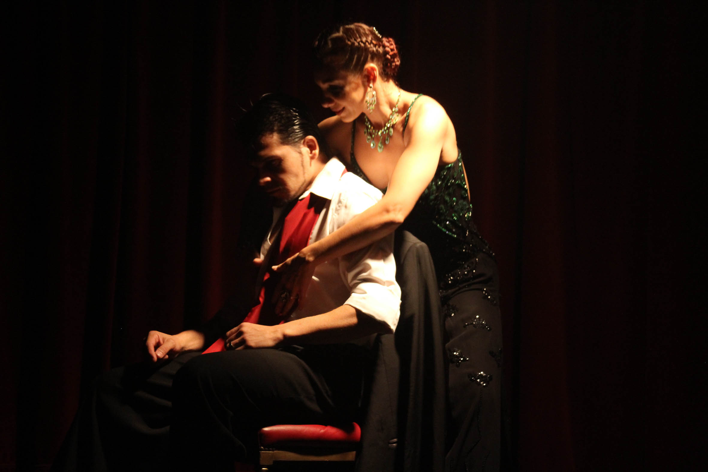 man sits on chair and feels sad and abandoned, woman hugs him from behind, both are feeling vulnerable