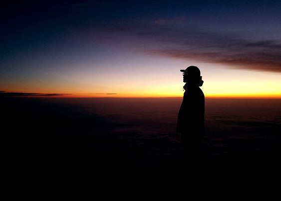 woman in front of the sunset, moving away from abuse towards love