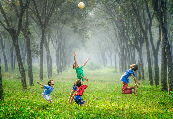 boys playing with a ball in the grass in the middle of trees, inner child healing