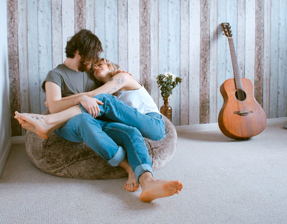 a couple, the woman is sitting on her partner's lap, hugging and cuddling, good relationship rules