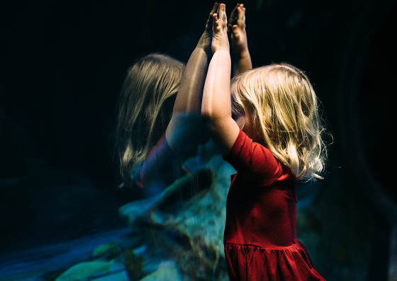 child on the mirror, lifting her hands up, another child in the mirror, inner child healing