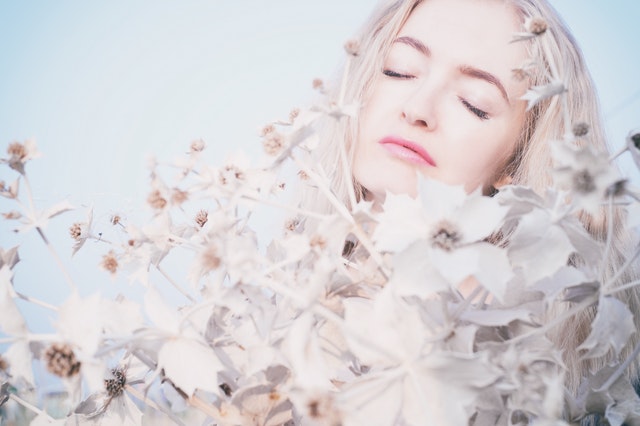 woman surrounded by beautiful white flowers, how to keep peace with a spouse