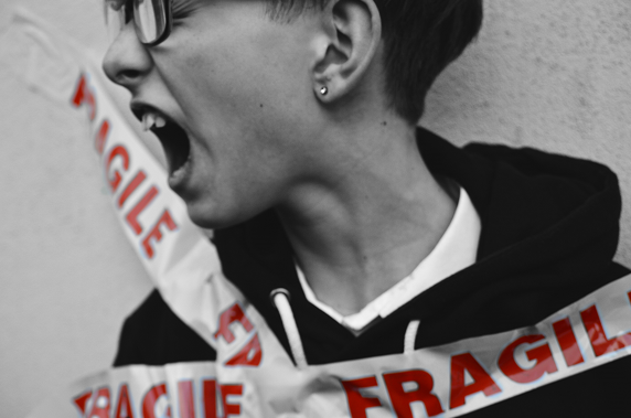 woman screaming wrapped around a banner with the words fragile, what does it mean to be vulnerable in a relationship