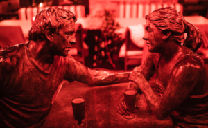 bronze figures, a man and a woman, in a cafe, criticism in relationship destroys